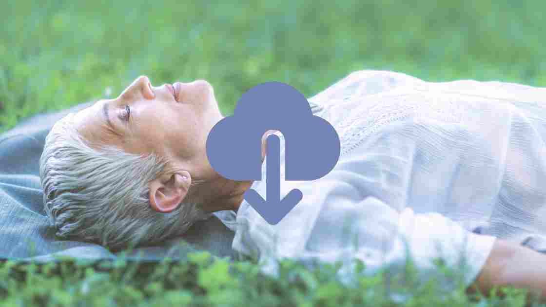 woman executive laying on the grass and using deep relaxation meditation